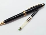 two pens sitting next to each other on a white surface