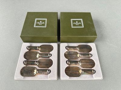 two green boxes with silverware in them sitting next to each other
