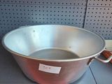 a large metal pan sitting on a shelf in a store