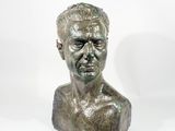 a close up of a bronze bust of a man on a white background