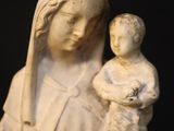 statue of a woman holding a child wearing a crown