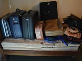 several pieces of luggage sitting on top of a bed in a room