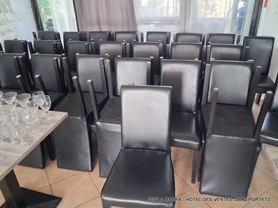 a room full of empty chairs and empty wine glasses on the table
