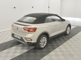 the rear end of a white volkswagen suv parked in a garage