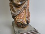 a statue of a woman that is sitting on top of a table