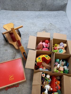 a box full of toys sitting on the floor next to a toy horse