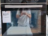 a man taking a picture of himself in the oven
