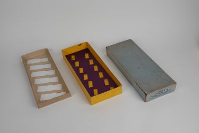 three boxes that are next to each other on a table