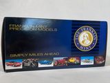 a close up of a box of miniature cars on a white surface