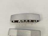 two pieces of metal on a white surface