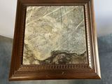 an image of a picture frame with a stone in it