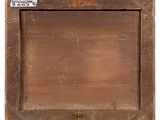an old wooden picture frame with a label on it