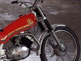 a red motorcycle that is parked in a garage