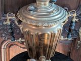 a silver vase sitting on top of a black table