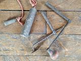 several tools are laid out on a wooden floor with a rope