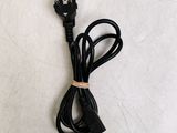 a black power cord that is attached to a white wall