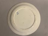 a white plate with a blue design on it