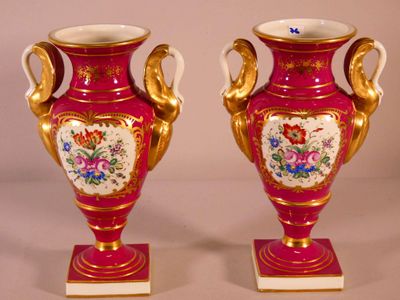 two vases that have been painted with flowers on them