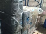 a large stack of pallets in a warehouse filled with boxes