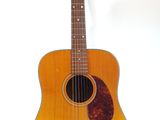 an image of a guitar on a stand against a white background