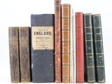 plusieurs vieux livres sont alignés sur une surface blanche