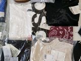 several pairs of shoes and clothes are laid out on a table