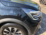 a close up of a black car parked in a parking lot