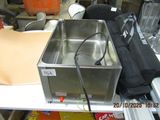 a metal container sitting on top of a white table