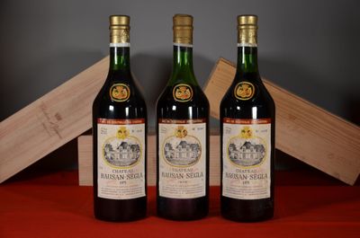 three bottles of wine sitting next to a wooden box on a table