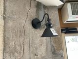 a light that is on the wall next to a window