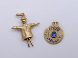 two charms of a person with a hat and a blue stone