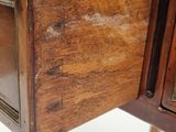 a close up of a wooden desk with a drawer on it