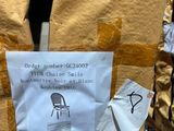 a piece of paper taped to the back of a chair