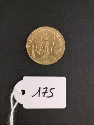 a small gold coin with a tag on it