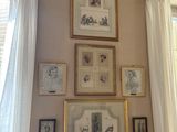 a picture of a living room with a couch and pictures on the wall