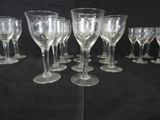 many empty wine glasses lined up on a table