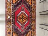 a rug hanging on a wall in a room