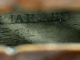 a close up view of a piece of wood with a word on it
