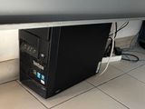 a computer that is sitting on the floor under a desk