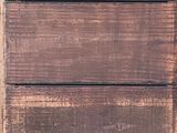 a cat that is sitting on a bench in front of a wooden door