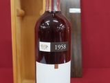 an image of a bottle of wine sitting next to a wooden box