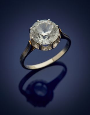 an old cut diamond ring on a blue background