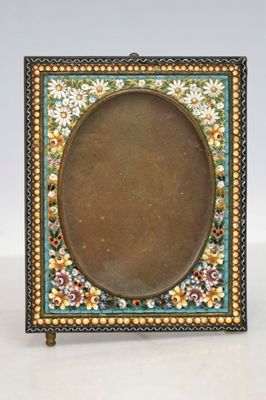 an old picture frame with a picture of flowers and leaves on it