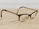 a pair of glasses sitting on a wooden table