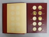 an open book with gold coins in it sitting on a table