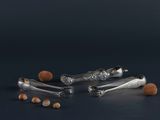 four silver spoons and two silver spoons on a black surface