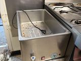 a sink and a stove in a kitchen next to each other