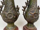 two vases that are sitting side by side on a table