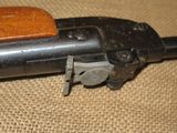 an old gun with a wooden handle on a burlock cloth