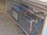 a refrigerator that is sitting on the ground under a tent